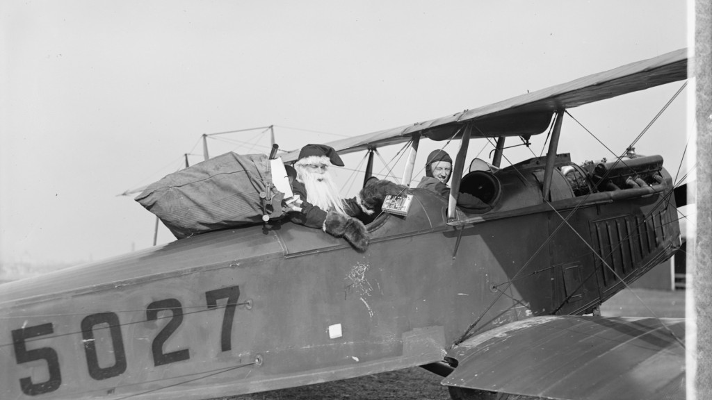 Santa in the rear seat of a bi-plane. Image from Library of Congress